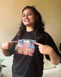 A satisfied customer wearing the Getting the Bus T-shirt inspired by Netflix's Sex Education, showcasing the vibrant red color and bold design, highlighting their love for the series