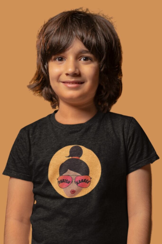A youth/boy wearing a Kids Parishkaaree Logo Tee in black, showcasing the iconic logo and comfortable fit.