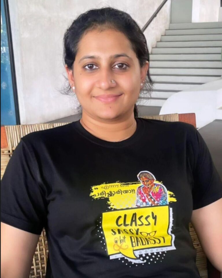 Happy customer wearing Parishkaaree T-shirt with Malayalam dialogue print.